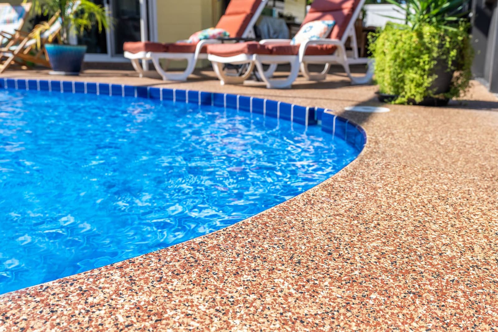 residential back patio deck surrounding pool coated with polyurea